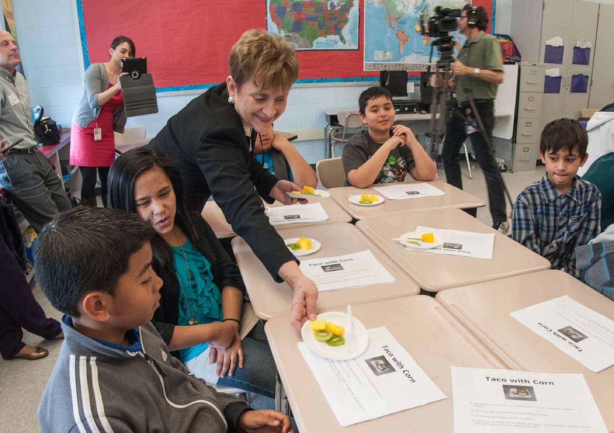 Teacher organizing classroom with students